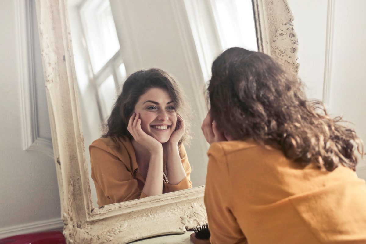 Woman Looking In Mirror